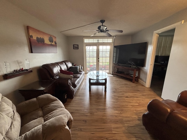 living room with a ceiling fan, french doors, and wood finished floors