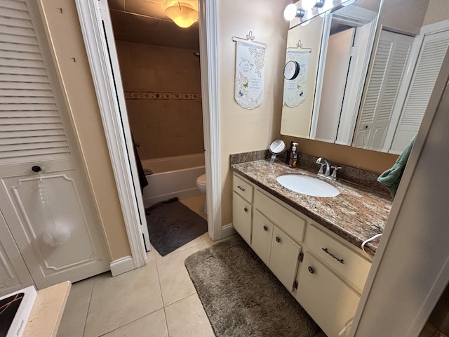 full bathroom featuring bathing tub / shower combination, toilet, tile patterned flooring, vanity, and a closet