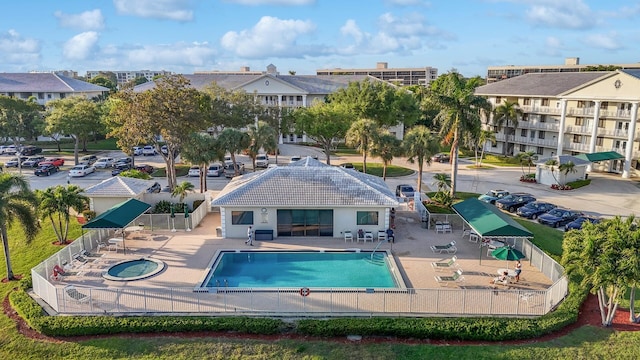 view of swimming pool featuring fence and a patio area