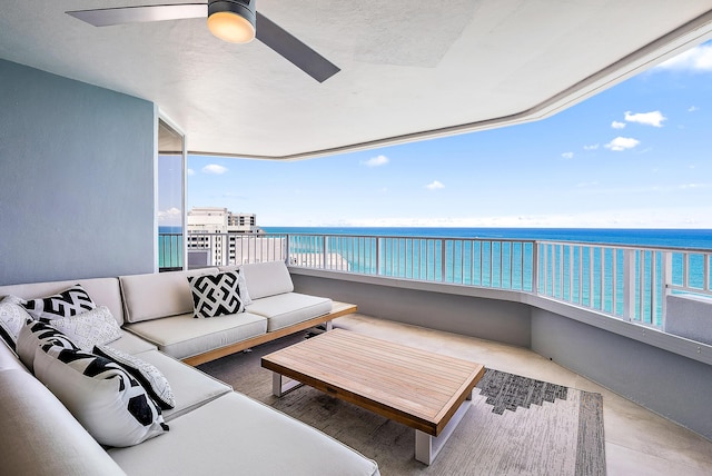 balcony featuring an outdoor hangout area, ceiling fan, and a water view