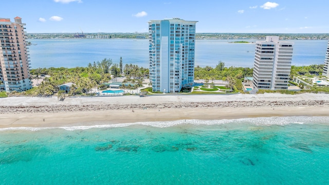 birds eye view of property with a water view, a view of city, and a view of the beach