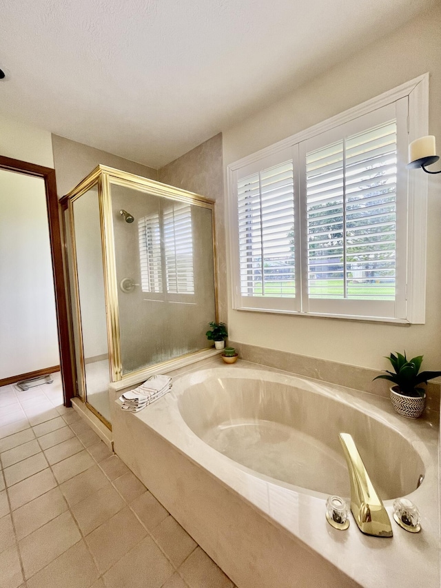 full bath with tile patterned flooring, a shower stall, and a bath