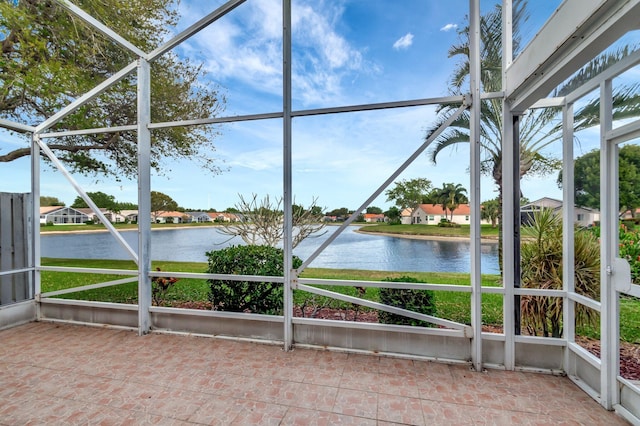 unfurnished sunroom with a water view