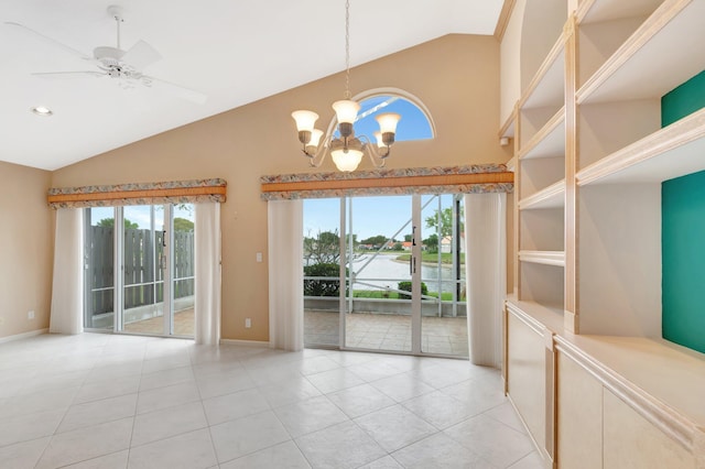 interior space with light tile patterned floors, plenty of natural light, and ceiling fan with notable chandelier