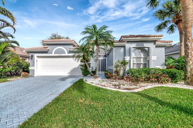 mediterranean / spanish-style home featuring a tiled roof, decorative driveway, an attached garage, and stucco siding