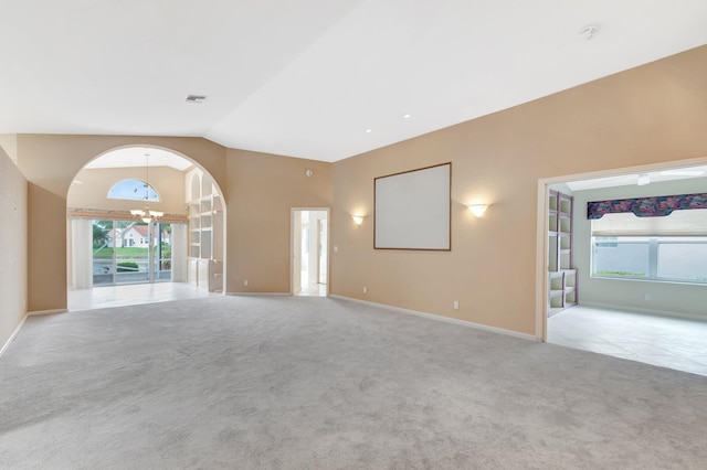 unfurnished living room featuring baseboards, visible vents, lofted ceiling, carpet floors, and a chandelier