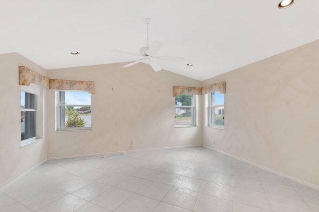 unfurnished room with a ceiling fan, lofted ceiling, a healthy amount of sunlight, and baseboards