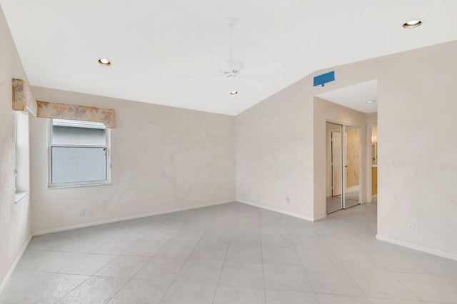 empty room featuring lofted ceiling, recessed lighting, a ceiling fan, and baseboards