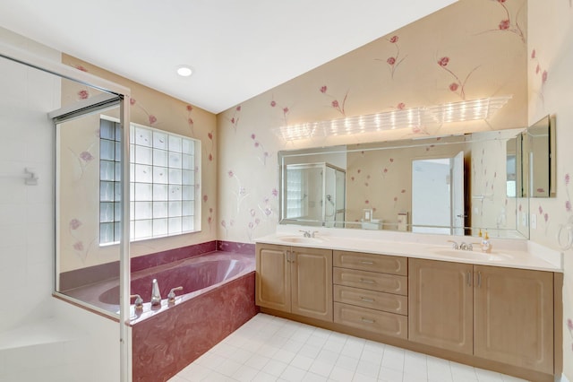 bathroom with a garden tub, a sink, a shower stall, and double vanity