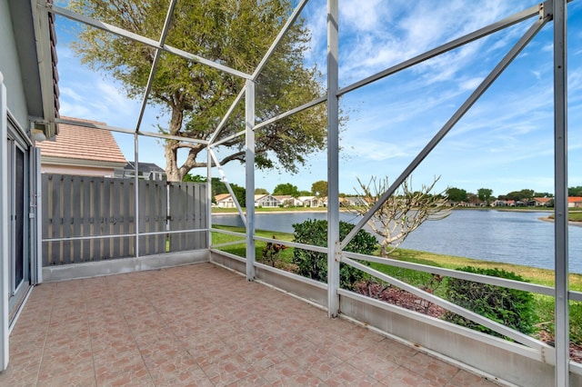 unfurnished sunroom featuring a water view