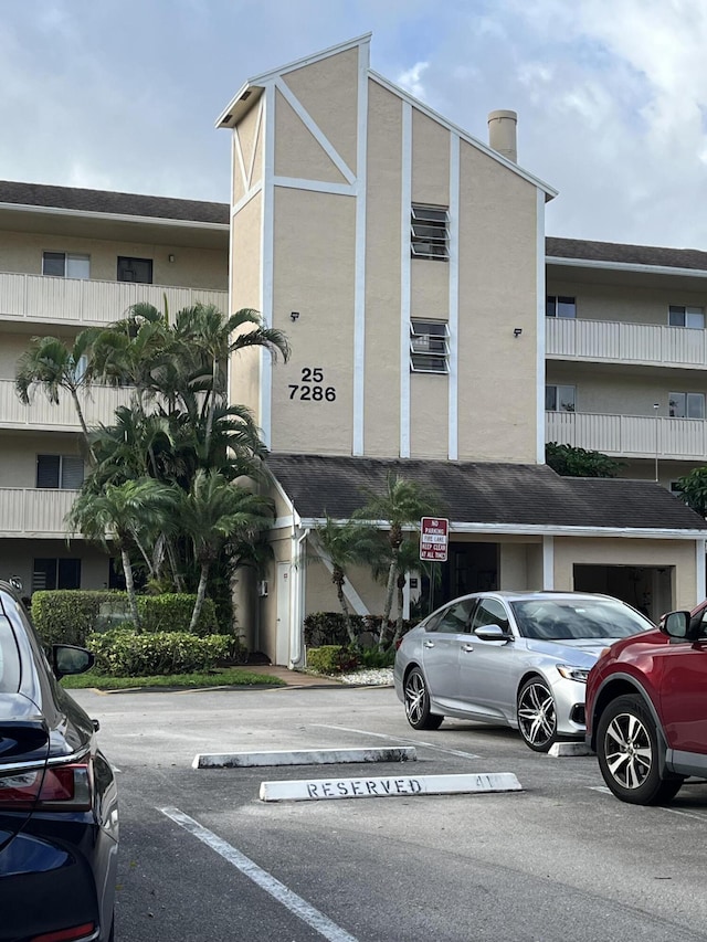 view of building exterior with uncovered parking