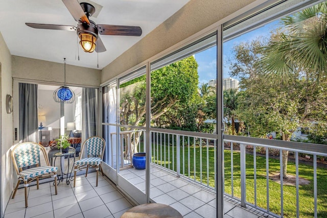 sunroom featuring ceiling fan