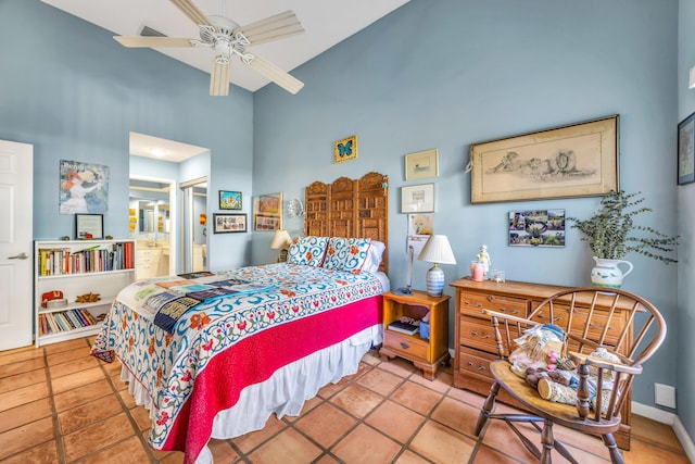 bedroom featuring visible vents, a high ceiling, ensuite bathroom, baseboards, and tile patterned floors