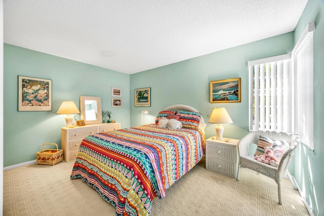 bedroom with carpet flooring, a textured ceiling, and baseboards