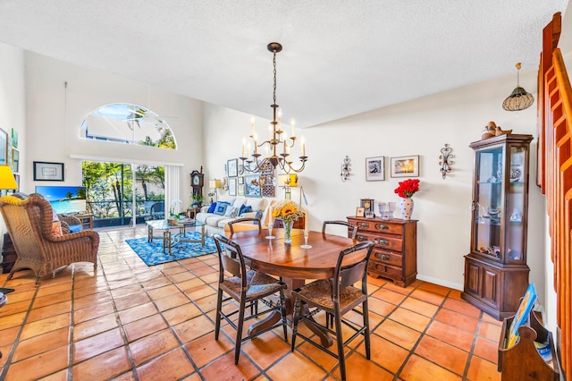 dining room with light tile patterned floors, baseboards, a towering ceiling, a textured ceiling, and a chandelier