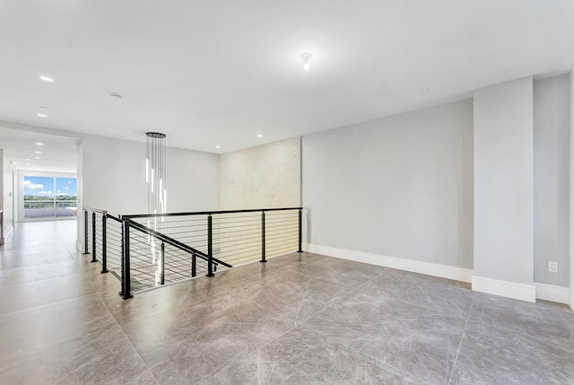 empty room featuring recessed lighting and baseboards