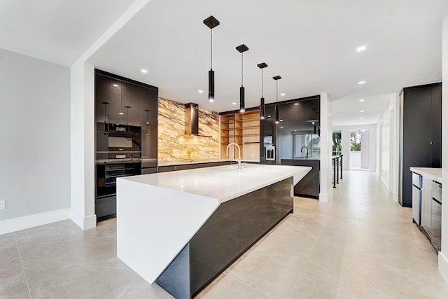 kitchen featuring range hood, modern cabinets, pendant lighting, and light countertops