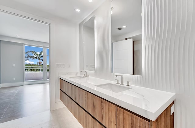 bathroom featuring double vanity, visible vents, and a sink