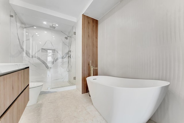 bathroom featuring a freestanding tub, toilet, vanity, and a marble finish shower