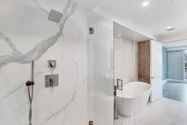 bathroom with a marble finish shower, visible vents, and a freestanding bath