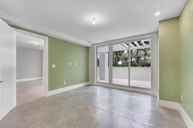 unfurnished room featuring baseboards