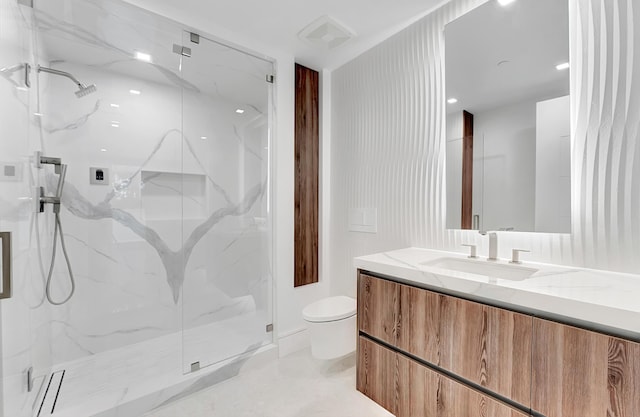 bathroom with toilet, a marble finish shower, visible vents, and vanity