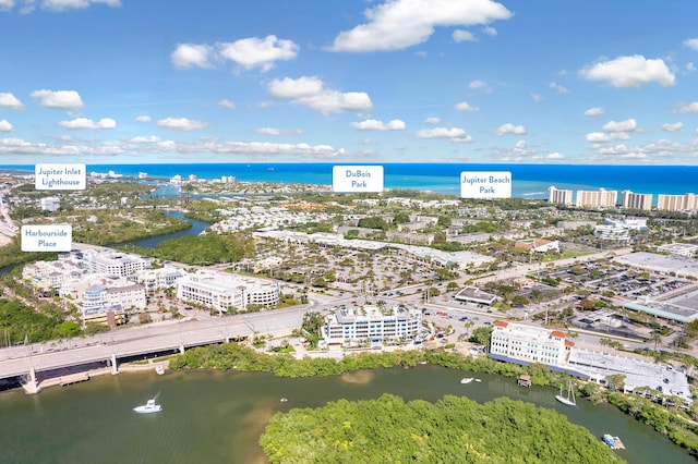 birds eye view of property featuring a water view and a view of city