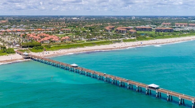 birds eye view of property featuring a water view and a view of the beach