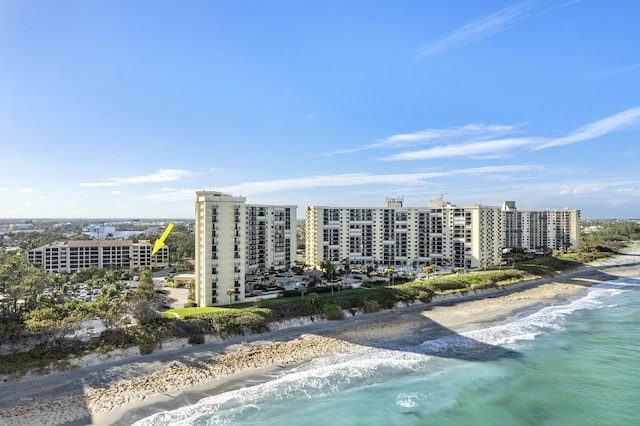 birds eye view of property with a view of city, a beach view, and a water view