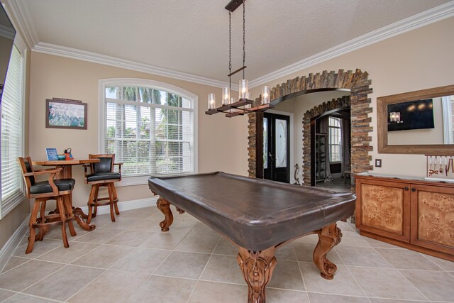 recreation room featuring arched walkways, light tile patterned flooring, ornamental molding, and billiards