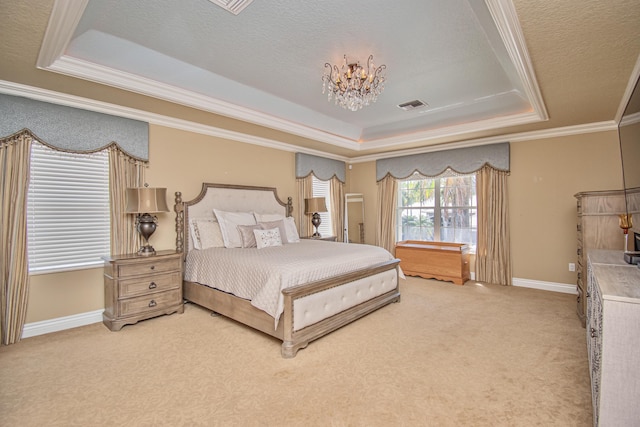 bedroom with a chandelier, crown molding, visible vents, a raised ceiling, and carpet