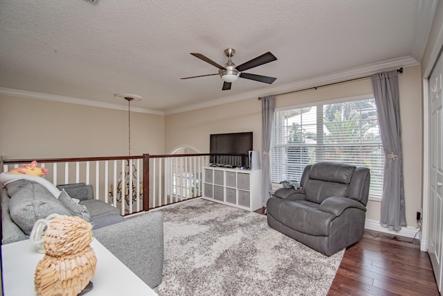 living room featuring dark wood-style flooring, a ceiling fan, crown molding, and a textured ceiling