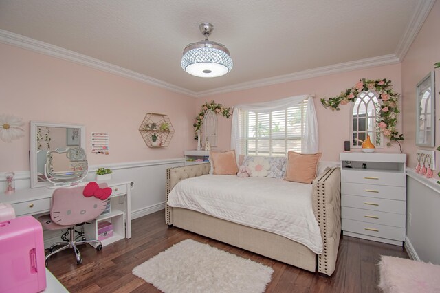 bedroom featuring wood finished floors, baseboards, and ornamental molding