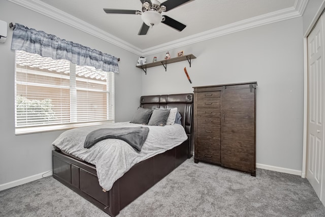 carpeted bedroom featuring ornamental molding, baseboards, and a ceiling fan