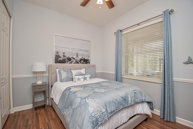 bedroom with a closet, baseboards, a ceiling fan, and wood finished floors
