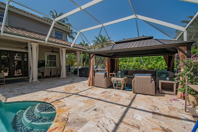 view of patio / terrace with outdoor lounge area, a ceiling fan, a gazebo, and a lanai