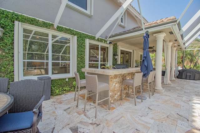 view of patio / terrace featuring outdoor dry bar and ceiling fan
