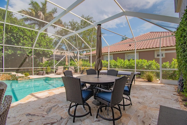 pool with glass enclosure and a patio