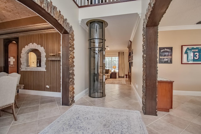 interior space with baseboards and ornamental molding