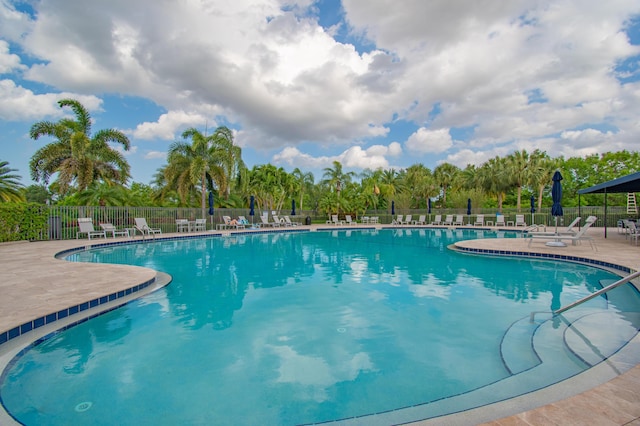 community pool featuring a patio and fence