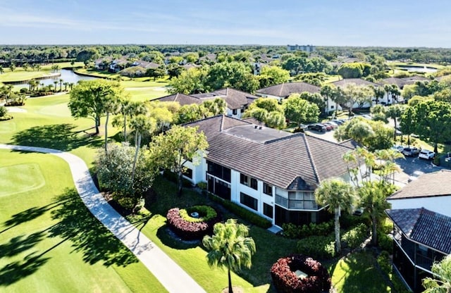 birds eye view of property with a water view and golf course view