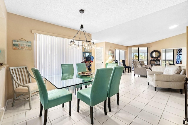 dining room with vaulted ceiling, a notable chandelier, light tile patterned flooring, and a textured ceiling