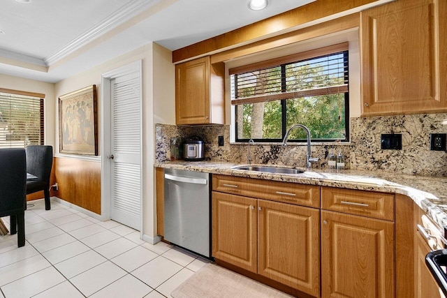 kitchen with a sink, crown molding, light tile patterned floors, decorative backsplash, and dishwasher