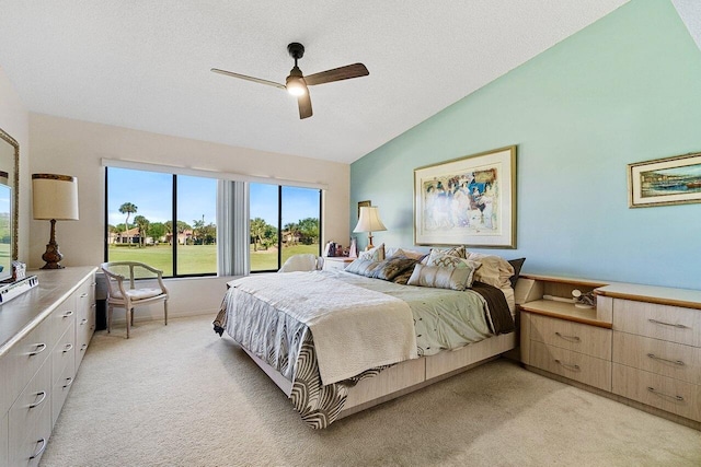 bedroom with light carpet, a textured ceiling, a ceiling fan, and lofted ceiling