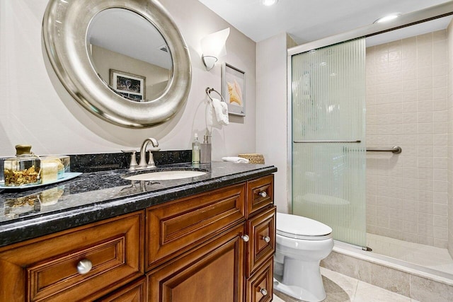 full bath with tile patterned floors, toilet, a stall shower, and vanity