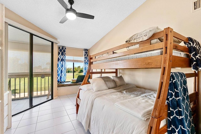 tiled bedroom featuring access to outside, a ceiling fan, visible vents, and a textured ceiling