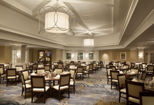 dining room with crown molding, decorative columns, beam ceiling, a decorative wall, and coffered ceiling