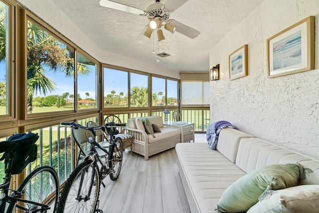 7290 Clunie Pl Unit 14404, Delray Beach, FL 33446 - sunroom featuring a textured ceiling, a textured wall, an outdoor hangout area, wood finished floors, and ceiling fan