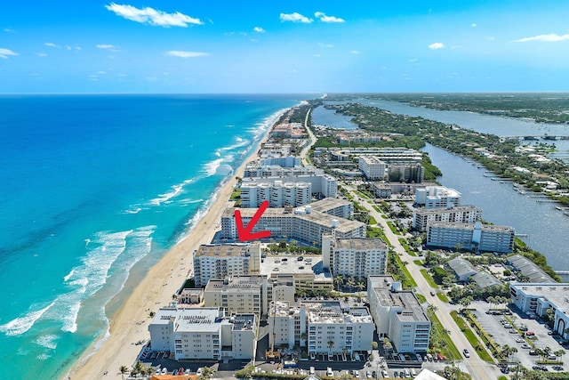 birds eye view of property featuring a beach view, a water view, and a city view