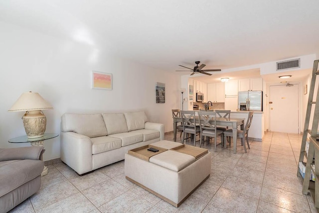 living room featuring ceiling fan, visible vents, and light tile patterned flooring